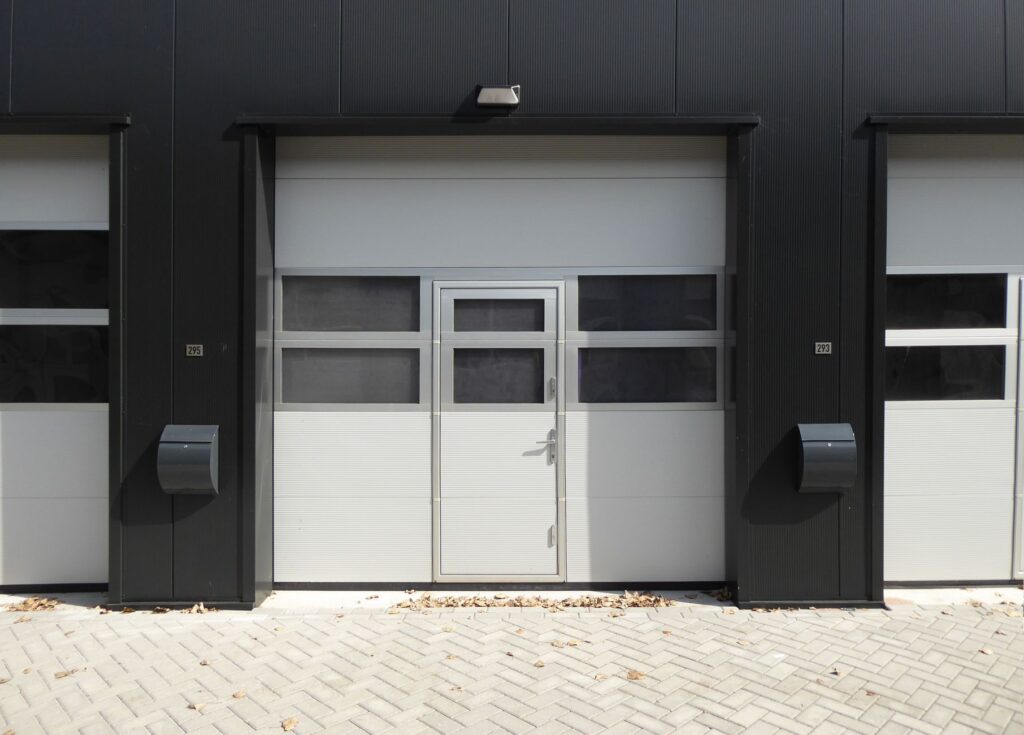 Gevel van een moderne bedrijfsunit met overheaddeur, illustratief bij bedrijfsruimte in Apeldoorn